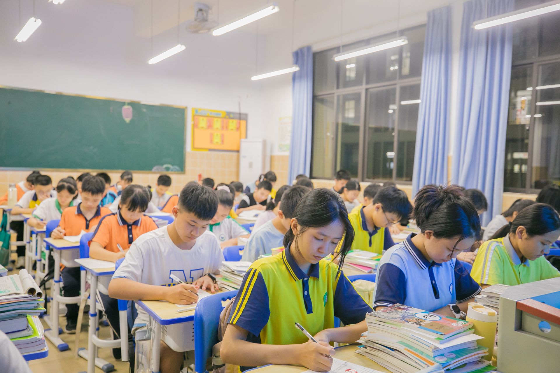 Students writing in a classroom during a lesson