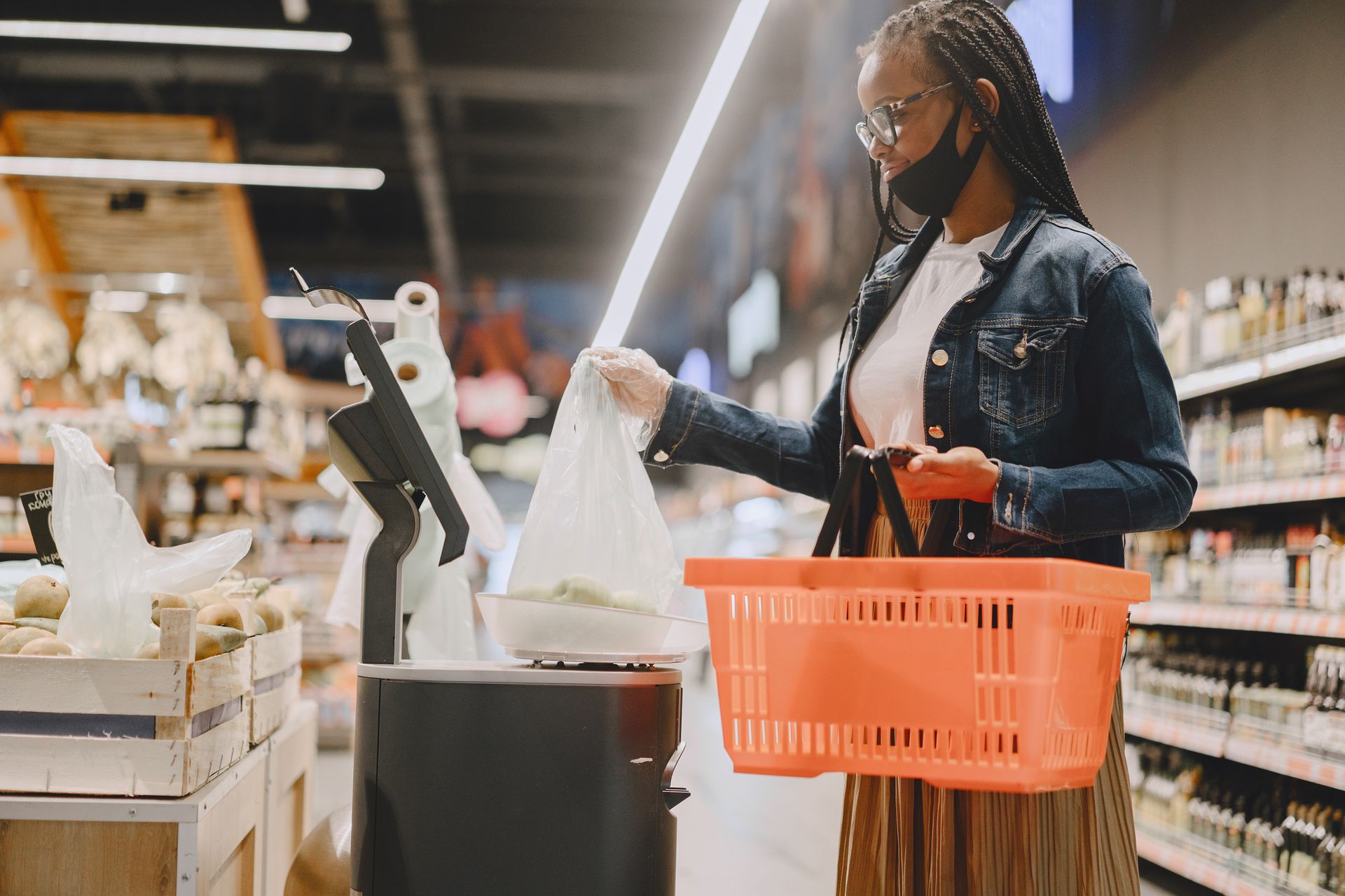 Young woman shopping in a grocery store with a basket