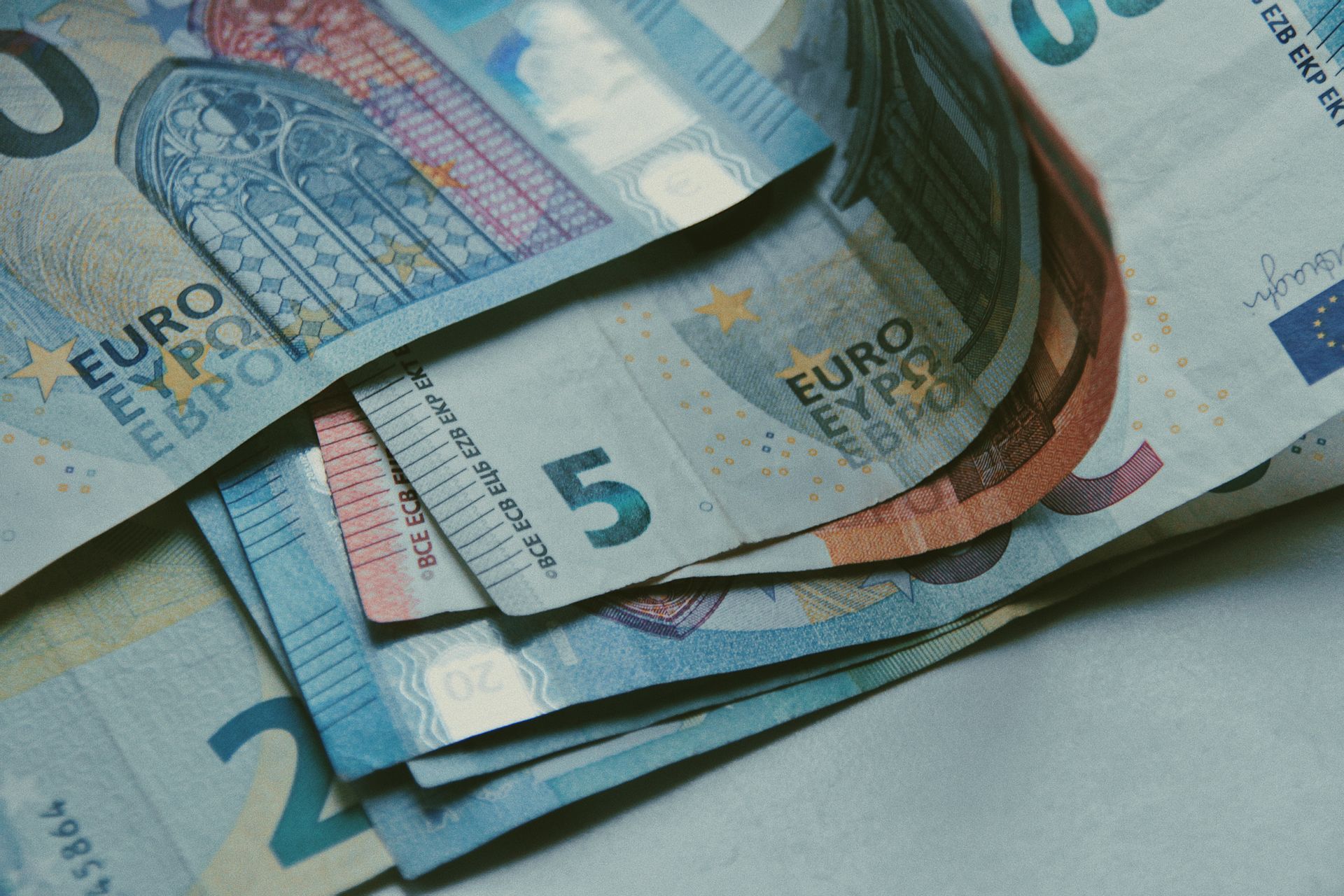 Euro banknotes on a white surface