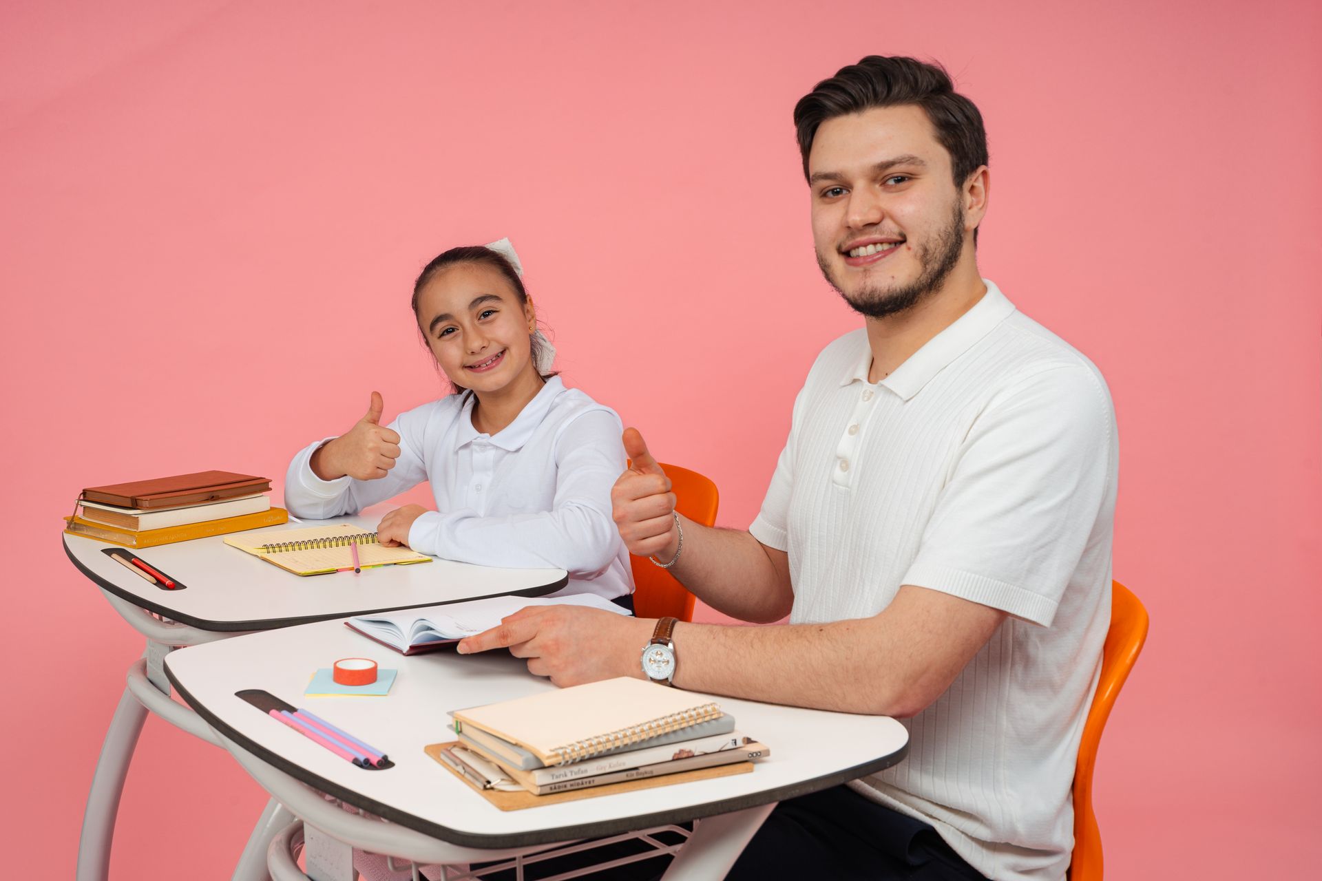 Teacher and student giving thumbs up at school
