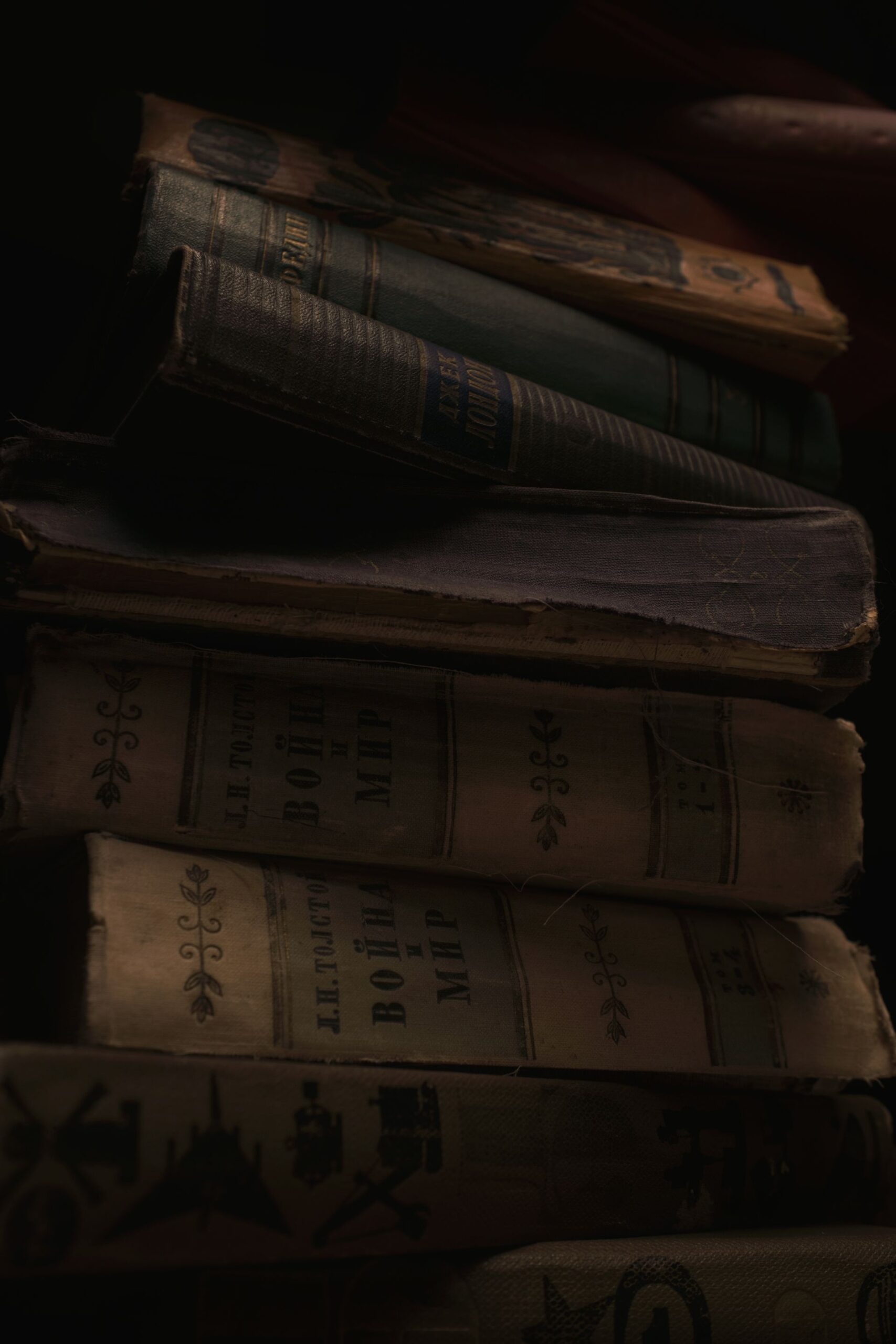 Stack of aged books with worn covers, antique vibe