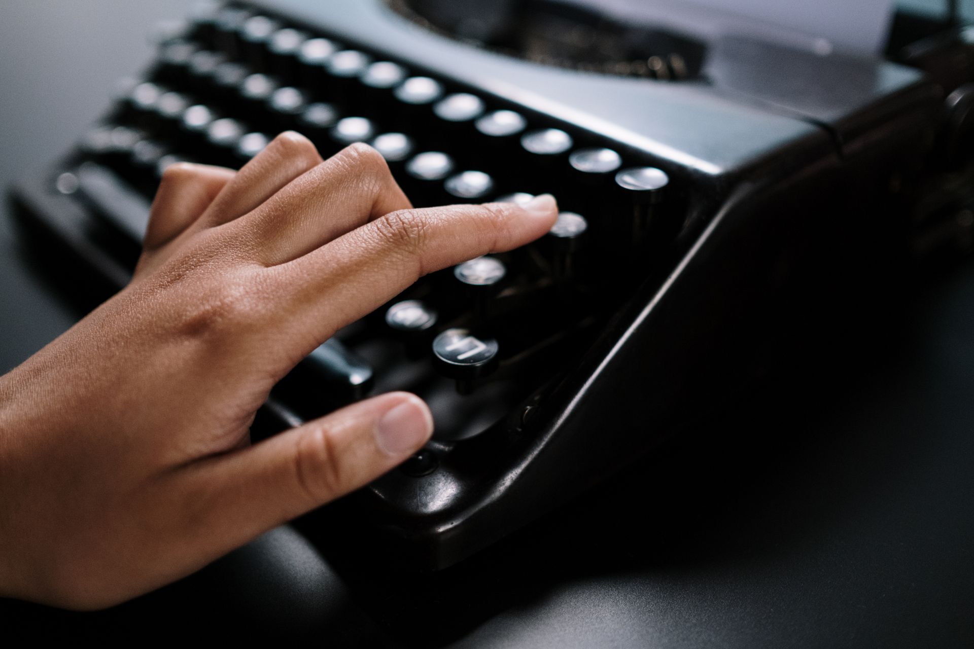 Woman writing on an old vintage typewriter