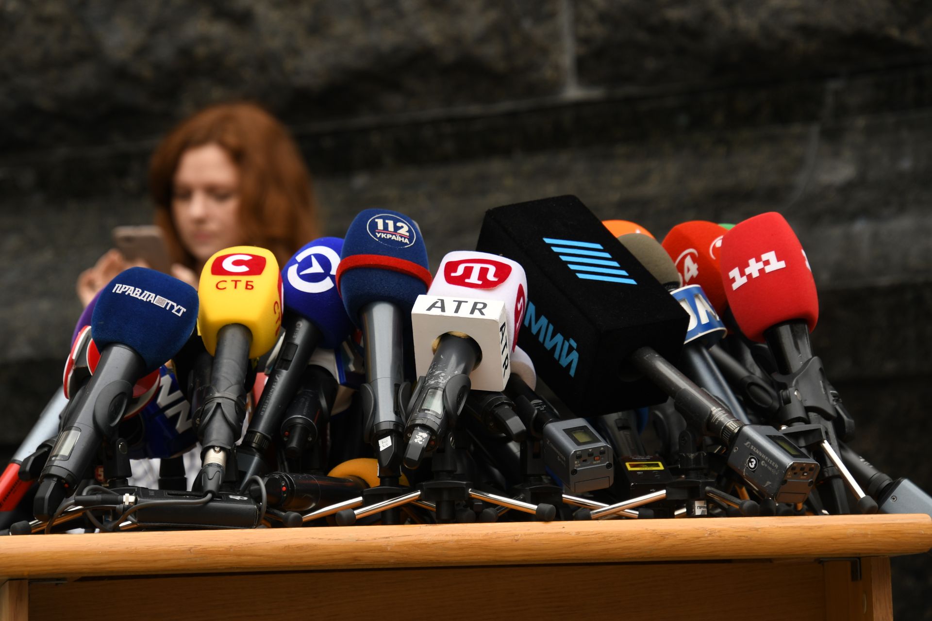 Row of microphones set up at a press conference
